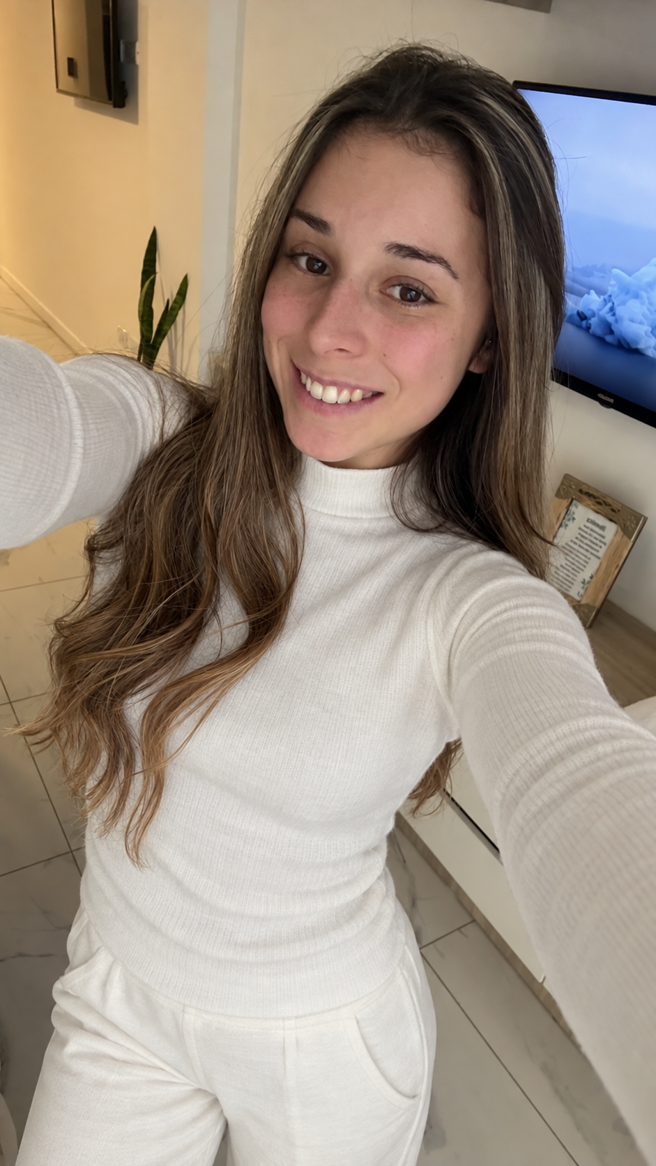 Ella smiling in a white outfit